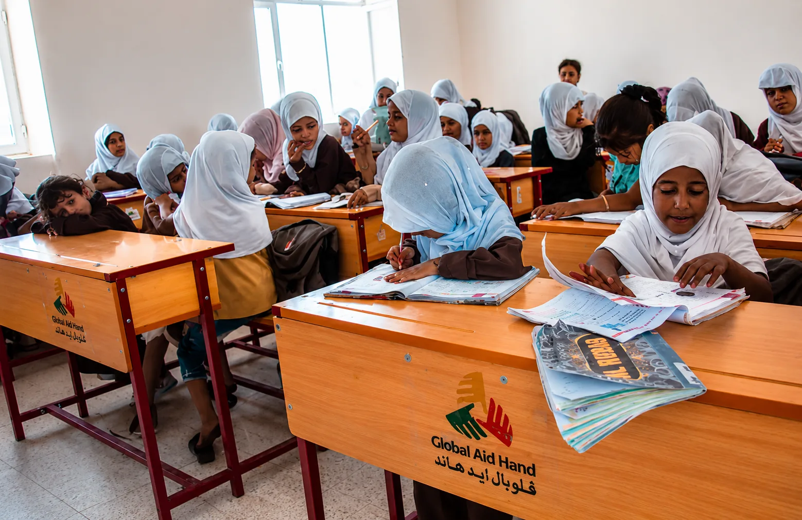 Yemeni girls studying at Global Aid Hand-supported classroom desks
